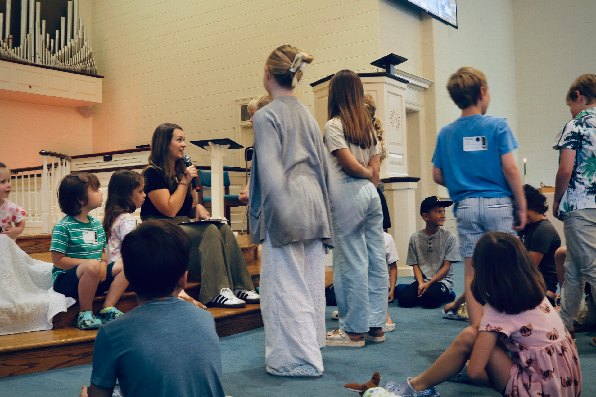 Welborne Kids leader speaking with children during a Sunday morning ministry gathering