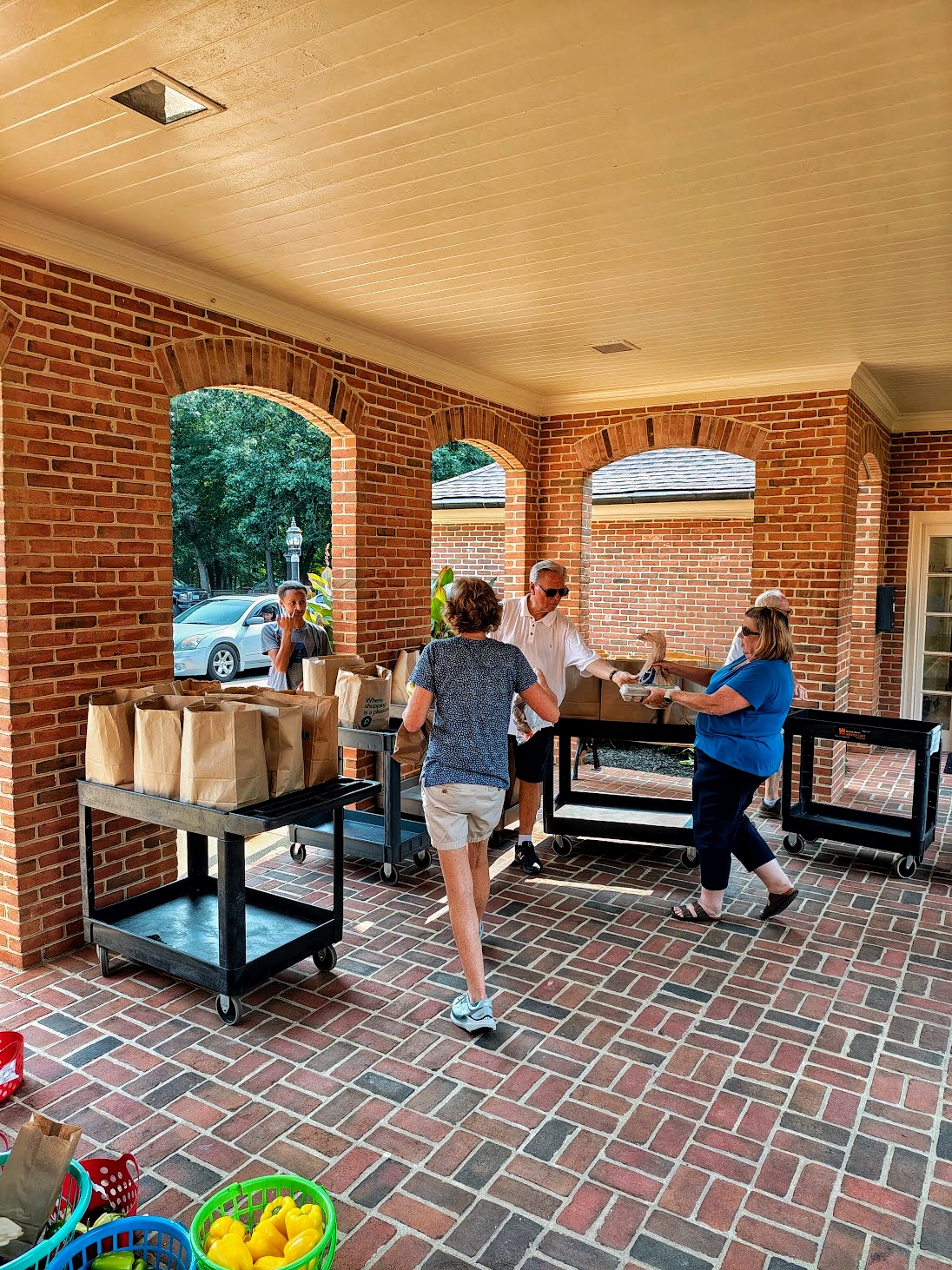 Volunteers handing out groceries on the church porch