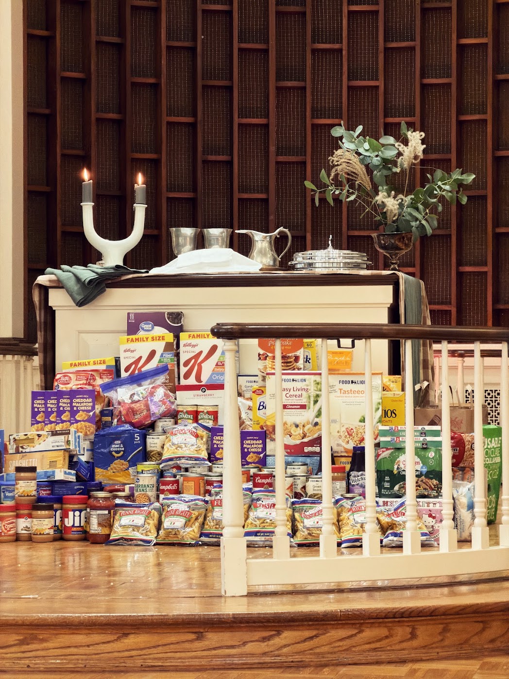 Donated food and supplies arranged on the Welborne church altar for the community food pantry